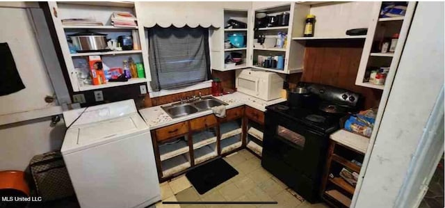 kitchen with sink, electric range, and washing machine and clothes dryer