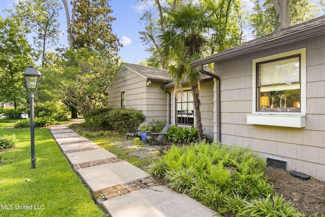 doorway to property featuring a lawn