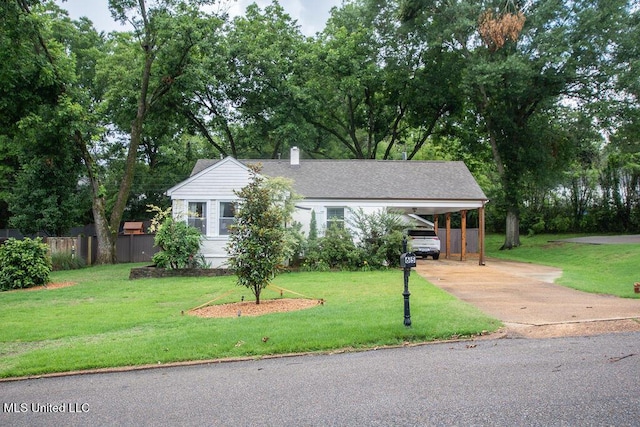 65 Vaiden Dr, Hernando, MS 38632 - view of front of house featuring driveway, a chimney, view of scattered trees, and a carport