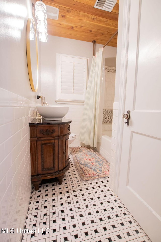 65 Vaiden Dr, Hernando, MS 38632 - bathroom featuring tile walls, vanity, shower / tub combo, wooden ceiling, and toilet
