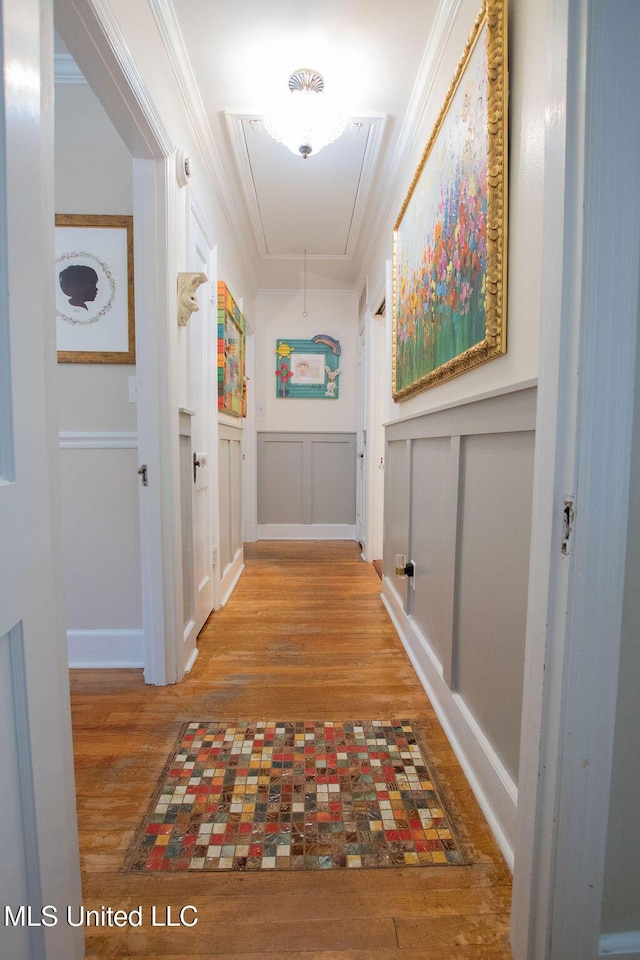 65 Vaiden Dr, Hernando, MS 38632 - hall featuring attic access, wood finished floors, a decorative wall, ornamental molding, and wainscoting