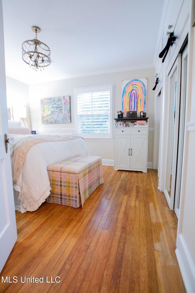 65 Vaiden Dr, Hernando, MS 38632 - bedroom featuring light wood finished floors, crown molding, a chandelier, and baseboards
