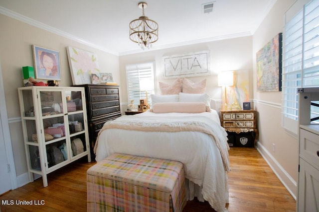 65 Vaiden Dr, Hernando, MS 38632 - bedroom featuring a chandelier, wood finished floors, crown molding, and baseboards