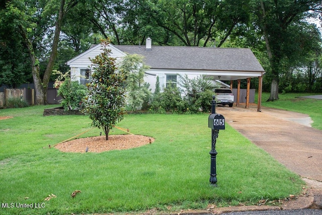 65 Vaiden Dr, Hernando, MS 38632 - view of front of house with a chimney, driveway, and a carport
