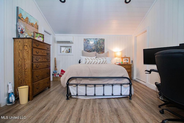 65 Vaiden Dr, Hernando, MS 38632 - bedroom with vaulted ceiling, wood finished floors, and a wall mounted AC