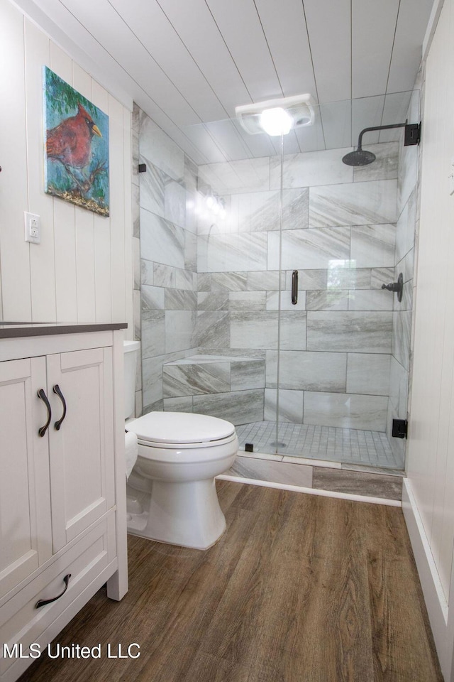 65 Vaiden Dr, Hernando, MS 38632 - bathroom with toilet, wood finished floors, a stall shower, and vanity