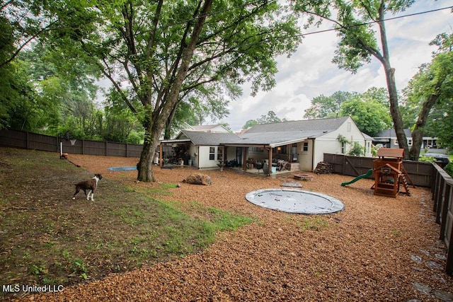 65 Vaiden Dr, Hernando, MS 38632 - rear view of house with a fenced backyard, a playground, and a patio area