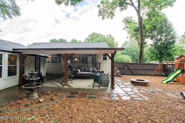 65 Vaiden Dr, Hernando, MS 38632 - back of house featuring a patio area, a fire pit, a playground, and brick siding