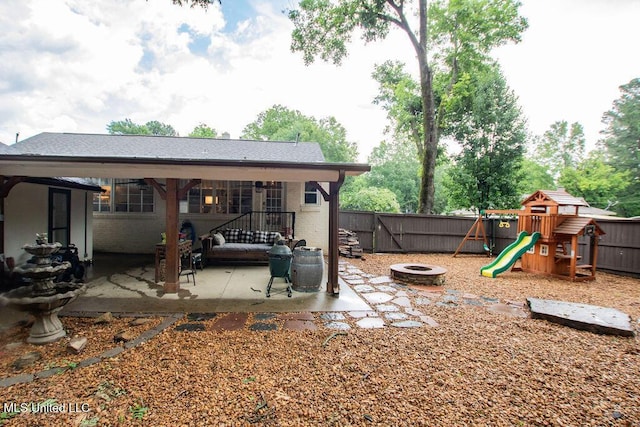 65 Vaiden Dr, Hernando, MS 38632 - fenced backyard with a patio area, a playground, and a fire pit