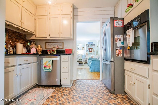 65 Vaiden Dr, Hernando, MS 38632 - kitchen with stainless steel appliances, dark countertops, and white cabinetry