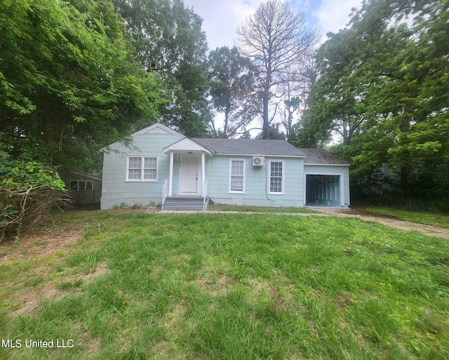 view of front of property with a front yard and a garage