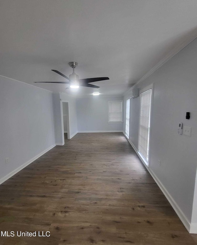 unfurnished room featuring dark wood-type flooring, crown molding, and ceiling fan