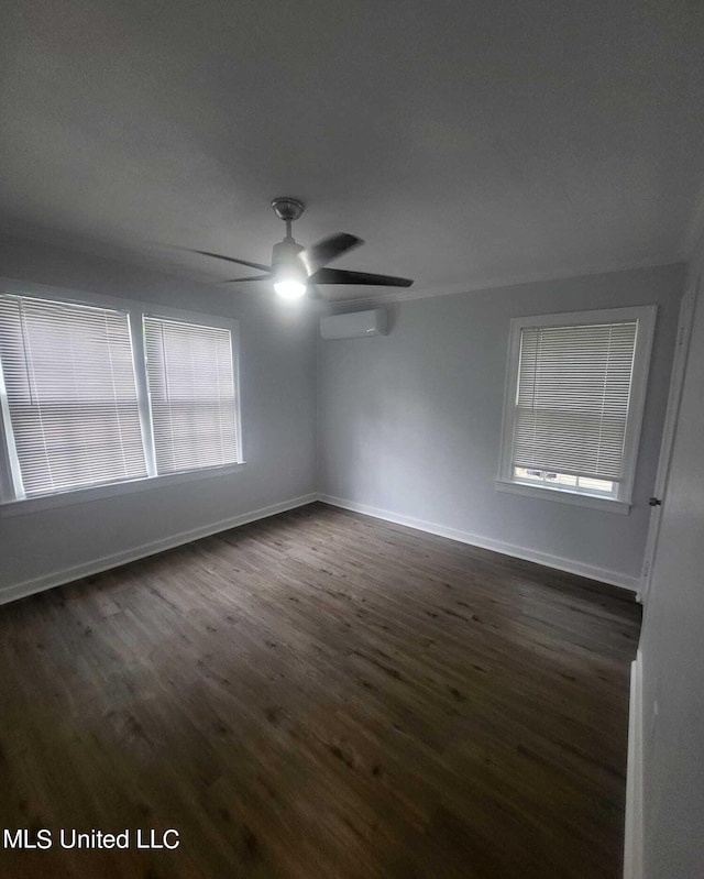 spare room with ceiling fan, a wall mounted air conditioner, and dark hardwood / wood-style flooring