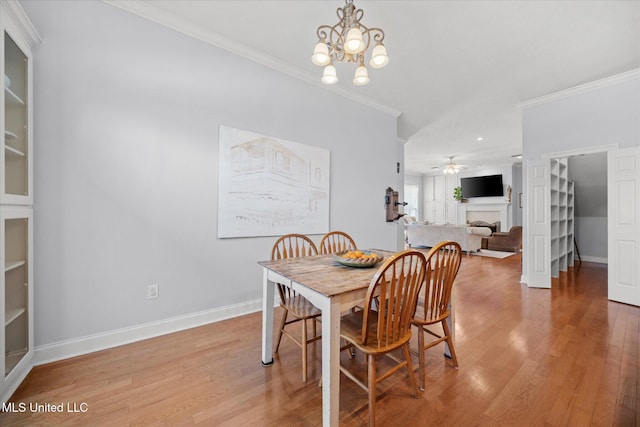 25 Savannah Cir, Brandon, MS 39047 - dining space with crown molding, light wood finished floors, a chandelier, baseboards, and a ceiling fan
