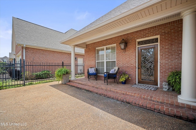 25 Savannah Cir, Brandon, MS 39047 - entrance to property with a porch, brick siding, roof with shingles, and fence