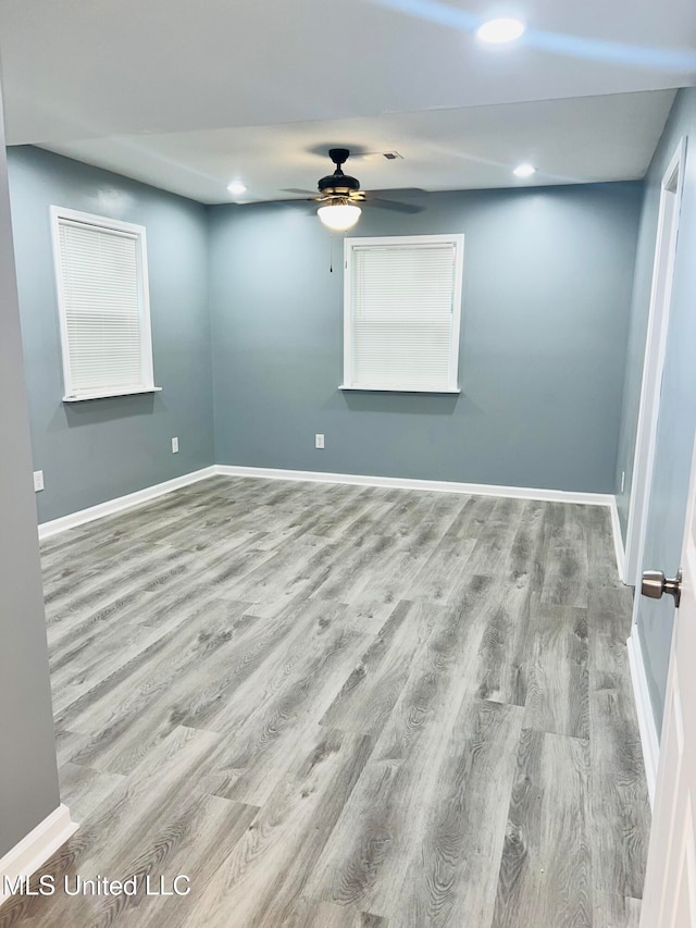 empty room featuring ceiling fan and light wood-type flooring