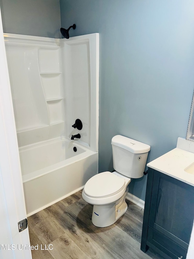 full bathroom with hardwood / wood-style floors, vanity, toilet, and bathtub / shower combination