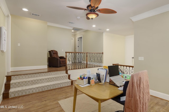 office featuring light wood finished floors, baseboards, crown molding, and recessed lighting