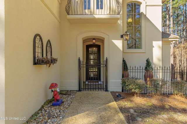 doorway to property with fence and stucco siding