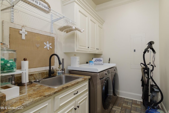 washroom with brick floor, cabinet space, a sink, separate washer and dryer, and electric panel