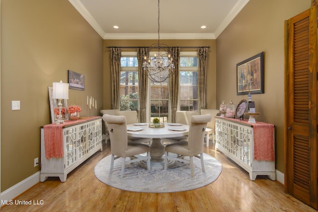 dining space featuring recessed lighting, crown molding, baseboards, light wood-style floors, and an inviting chandelier