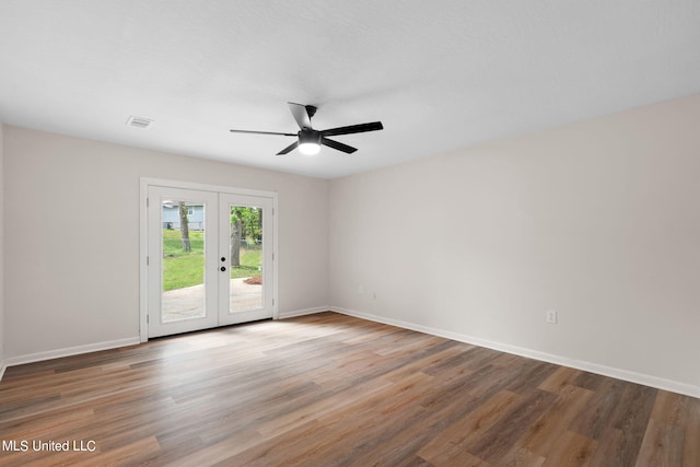 unfurnished room featuring hardwood / wood-style floors, french doors, and ceiling fan