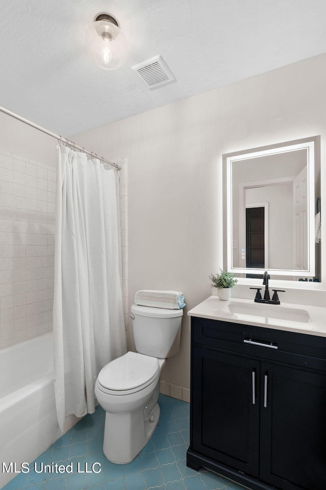 full bathroom with vanity, shower / bath combo with shower curtain, toilet, and tile patterned floors