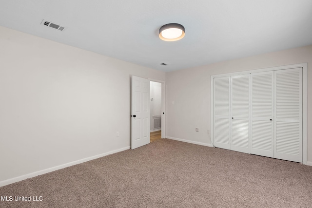 unfurnished bedroom featuring a closet and carpet flooring