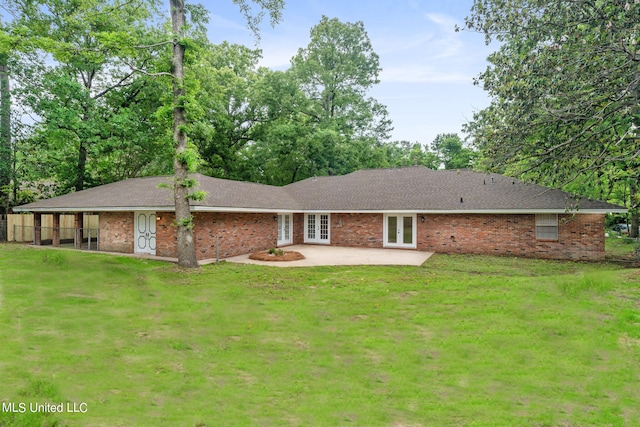 rear view of house featuring a patio and a yard