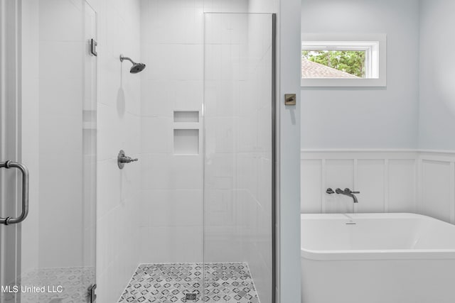 bathroom featuring separate shower and tub