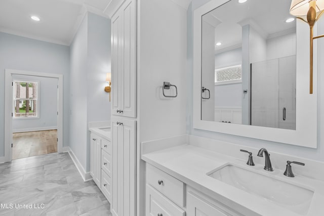 bathroom featuring vanity, an enclosed shower, and ornamental molding