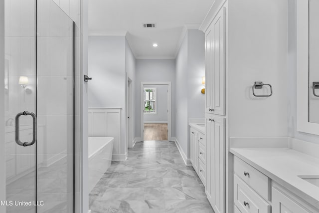 bathroom featuring vanity, crown molding, and shower with separate bathtub