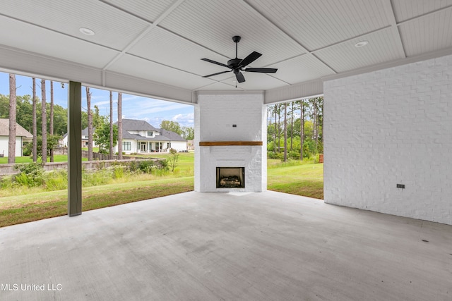 view of patio featuring a fireplace and ceiling fan