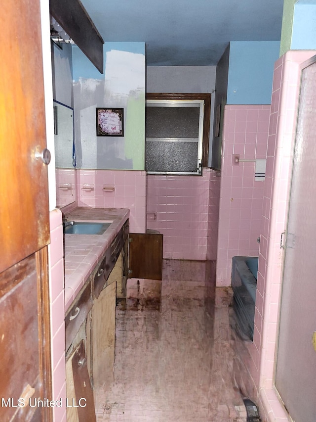818 Cedar Grove Ave, Picayune, MS 39466 - full bathroom featuring tile walls, vanity, a shower, and a wainscoted wall