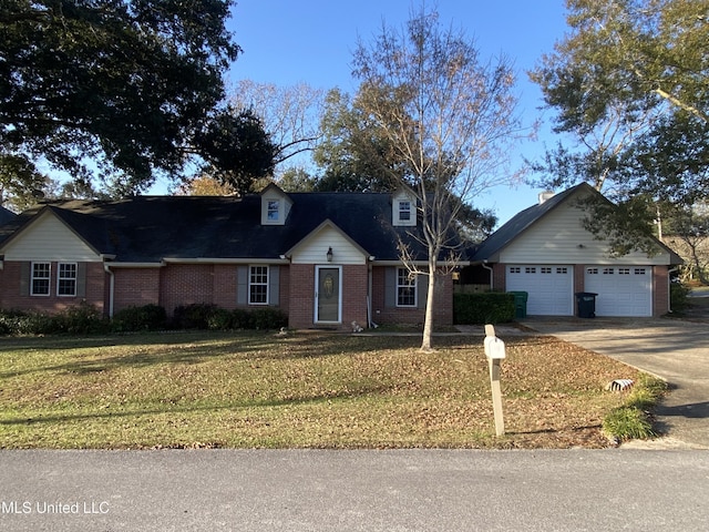 790 Ewa Pl, Diamondhead, MS 39525 - view of front of home featuring concrete driveway, a front lawn, a garage, and brick siding
