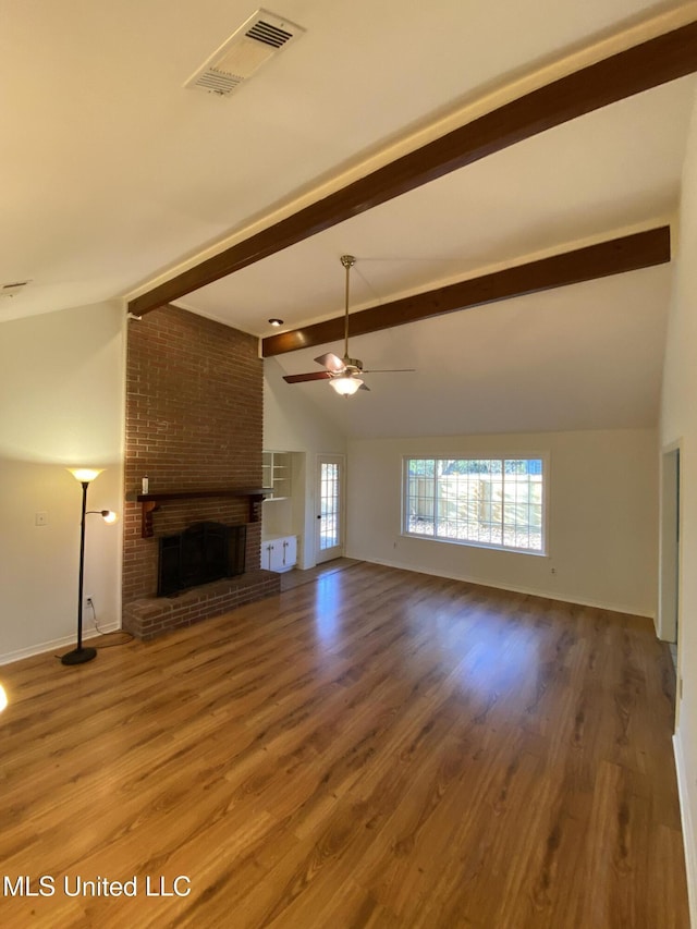 790 Ewa Pl, Diamondhead, MS 39525 - unfurnished living room featuring a brick fireplace, wood finished floors, and ceiling fan