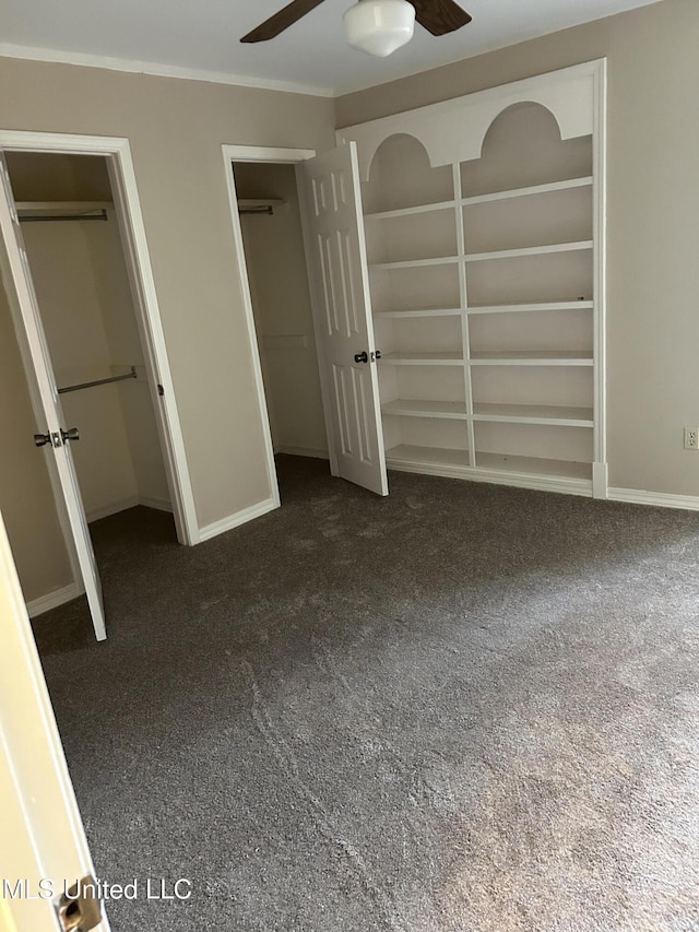 unfurnished bedroom with dark carpet and ceiling fan