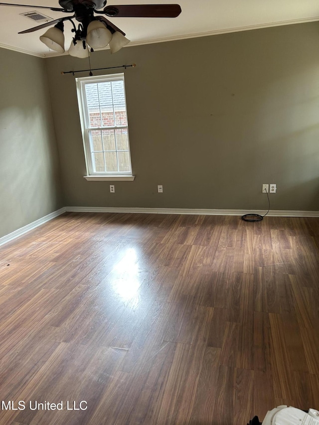 unfurnished room featuring dark hardwood / wood-style floors, ceiling fan, and ornamental molding