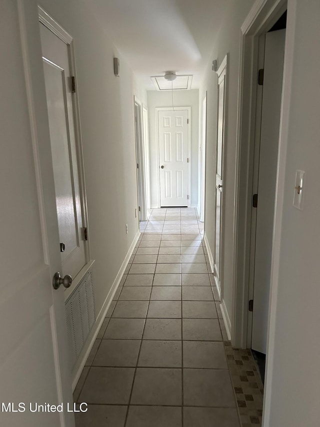 hall with light tile patterned floors