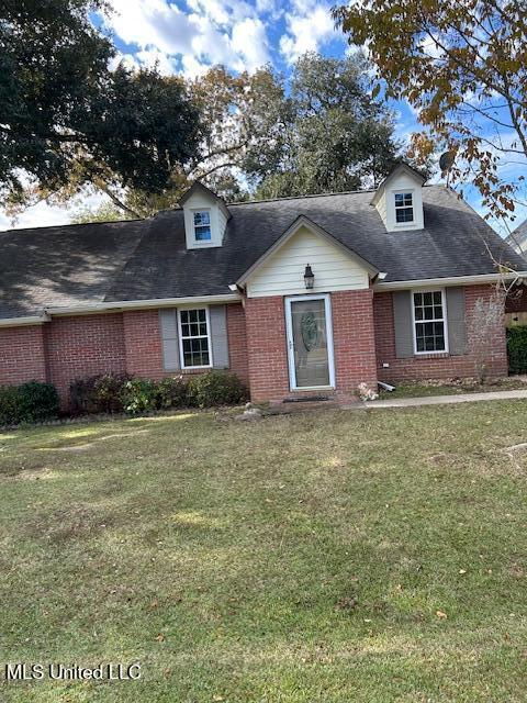 790 Ewa Pl, Diamondhead, MS 39525 - cape cod house featuring brick siding, a front lawn, and roof with shingles