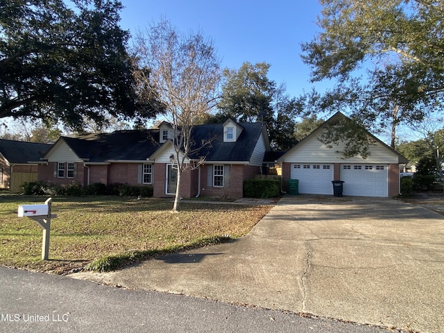 790 Ewa Pl, Diamondhead, MS 39525 - view of front of house with brick siding, a front yard, a garage, and an outbuilding