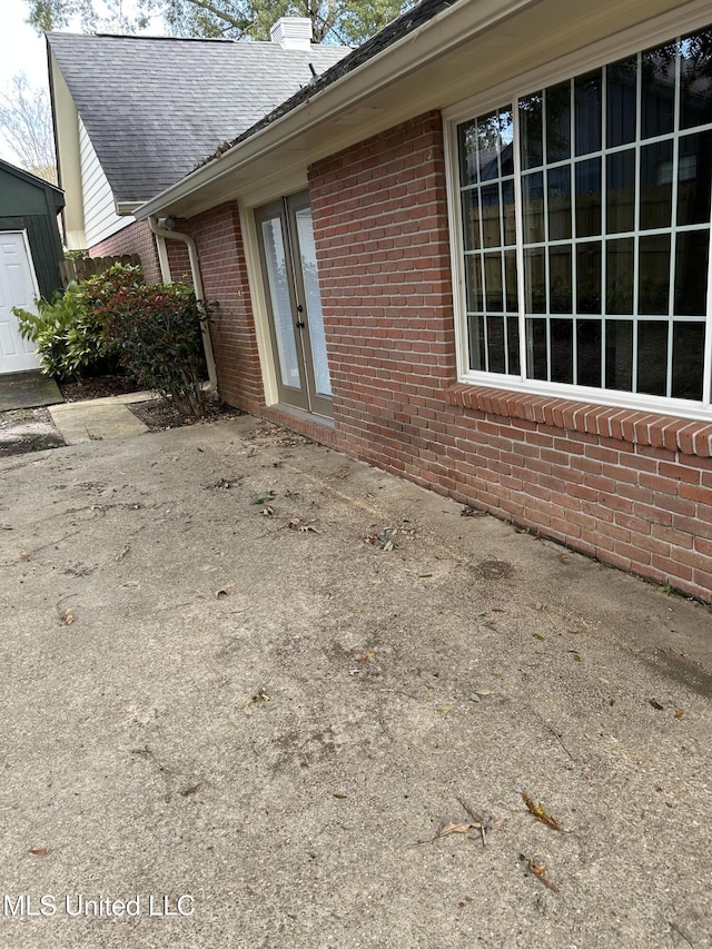 view of side of property with a patio