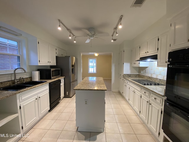 790 Ewa Pl, Diamondhead, MS 39525 - kitchen featuring black appliances, a kitchen island, under cabinet range hood, ceiling fan, and backsplash