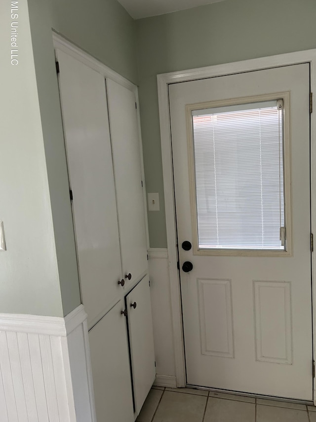 entryway with light tile patterned floors