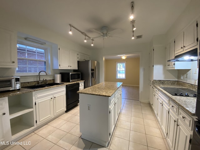 790 Ewa Pl, Diamondhead, MS 39525 - kitchen with black appliances, light tile patterned flooring, under cabinet range hood, a center island, and a ceiling fan