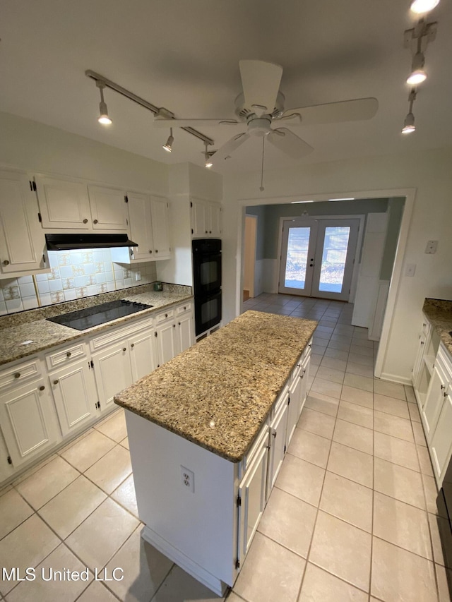 790 Ewa Pl, Diamondhead, MS 39525 - kitchen featuring black appliances, light tile patterned flooring, french doors, and white cabinetry