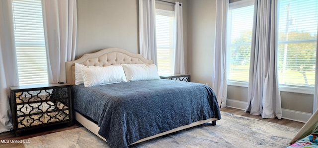 bedroom featuring baseboards and wood finished floors