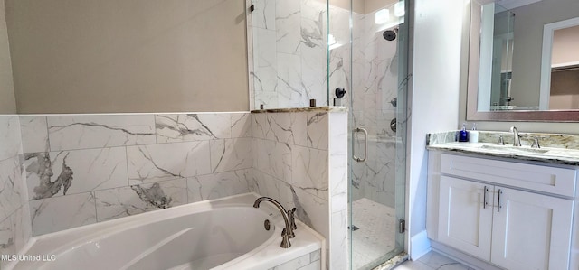 bathroom with marble finish floor, vanity, a marble finish shower, and a bath