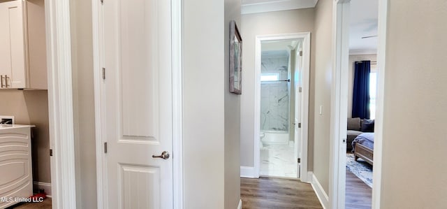 hall featuring wood finished floors and baseboards