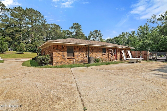 428 Simpson Cir, Mendenhall, MS 39114 - rear view of property featuring central AC, driveway, and brick siding